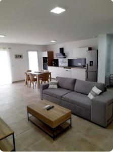 a living room with a couch and a table at Villa plain-pied au calme in Le Castellet