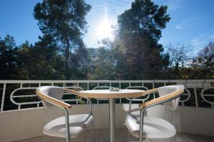 a table and two chairs on a balcony at UFO Rooms 2 in Tirana