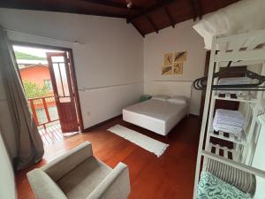 a living room with a bunk bed and a couch at Beach House Dunas da Joaquina in Florianópolis