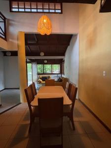 a dining room with a table and chairs at Beach House Dunas da Joaquina in Florianópolis +14 photos