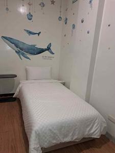 Postel nebo postele na pokoji v ubytování 愛之屋