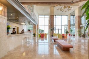 a lobby with benches and tables in a building at Ocean Resort Nomon長崎 in Nomo +19 photos