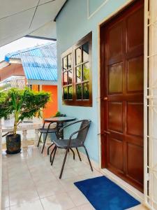 a door leading to a patio with a table and chairs at Friends Retreat - Phuket Airport in Ban Bo Han