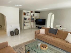 a living room with a couch and a tv at Il Nido by Fewotessin in Ronco sopra Ascona