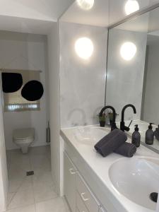 a bathroom with a sink and a toilet and a mirror at Il Nido by Fewotessin in Ronco s/Ascona - Porto Ronco +29 photos