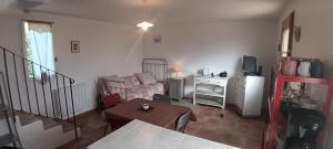 a living room with a couch and a table at Le Petit Mas des Hauts de Beyssan, Maison de vacances avec piscine privative pour 2 personnes in Gargas