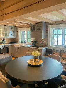 a large kitchen with a table and chairs at Log Cabin With Panoramic Views At Voss Resort in Skulestadmo