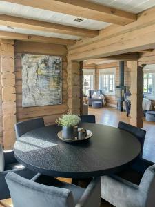 a dining room with a black table and chairs at Log Cabin With Panoramic Views At Voss Resort in Skulestadmo