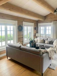 a living room with a couch and a table at Log Cabin With Panoramic Views At Voss Resort in Skulestadmo +9 photos