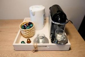 a bottle of wine and glasses on a table at Le Studio Cocooning in Chartres +5 photos