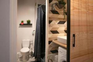 a bathroom with a toilet and a sink at Le Studio Cocooning in Chartres