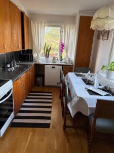 a kitchen with a table and a sink and a stove at Joyce holiday place in Hanko +22 photos