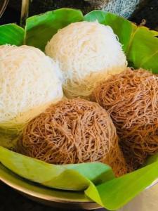 a plate of food with rice and noodles at Tikla safari lodge in Udawalawe
