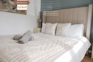 a bedroom with a large bed with white sheets and pillows at 3BR House By MyStayUK Short Lets & Serviced Accommodation Manchester With Free Wifi & Free Parking in Manchester
