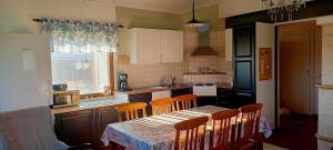 a kitchen with a table and chairs and a kitchen with a table and a kitchen at Kotariipi in Saukkoriipi