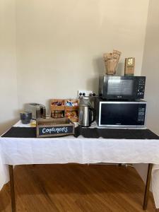 a table with a counter top with a microwave at Jerilderie Hotel in Jerilderie +9 photos
