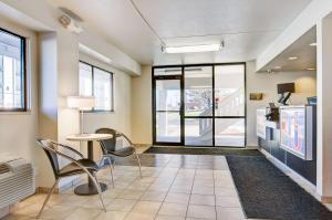 a lobby with a table and chairs and a kitchen at Economy Suites Springfield - Extended Stay in Springfield