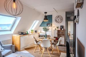 a small kitchen and dining room with a table and chairs at Cocon - Sélestat - Parking gratuit - Proche Europa-Park - Route des Vins - Haut-Koenigsbourg in Sélestat