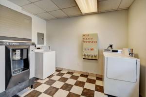 a kitchen with white appliances and a checkered floor at Motel 6-Seekonk, MA - Providence East in Seekonk
