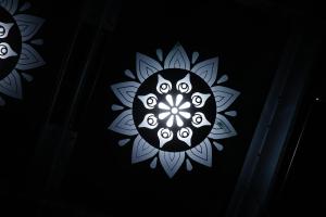 a black and white mandala on a black background at Shri Hari Executive Lodge in Tuljapur