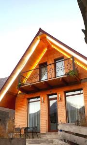 a house with a balcony on the front of it at Mountain flower cottage in Stepantsminda