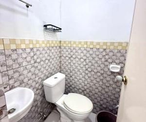 a bathroom with a toilet and a sink at Wakim’s INN in Coron +15 photos