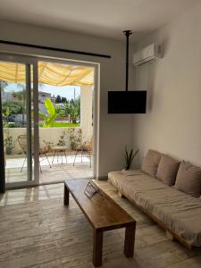 a living room with a couch and a coffee table at Greco Mare 99 in Kavos
