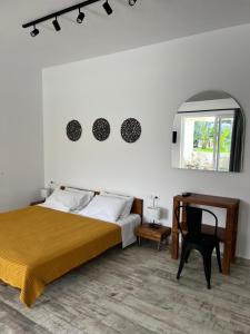 a bedroom with a bed and a desk and a window at Greco Mare 99 in Kavos