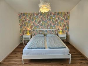 a bedroom with a bed and a colorful wall at Casa Colombina Duplex by Fewotessin in Gordola