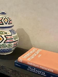 a vase sitting on top of a stack of books at Villa Atika in El Bougaria