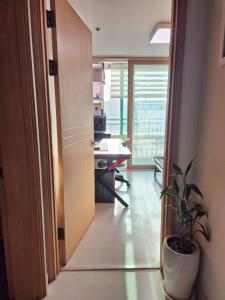 an open door to an office with a potted plant at Healing Gangchu in Anyang