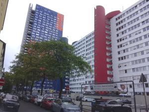 a city street with cars parked in front of tall buildings at Graeff sweet apartment in Cologne