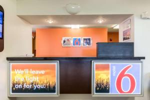 a reception desk with two signs on it at Motel 6-Percival, IA in Percival