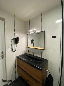 a bathroom with a sink and a mirror at L'Instant Loire in Saumur