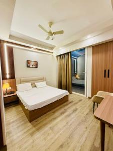 a bedroom with a bed and a table and a couch at SR Luxury steys in Greater Noida