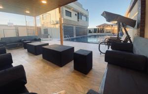 un salon avec des canapés et une piscine dans l'établissement For daily, weekly monthly and yearly stays, à Amman