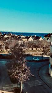 a car parked in a parking lot next to a building at Seaview and swimming in Hellerup +9 photos