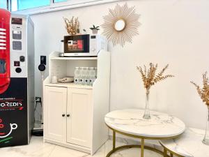 a room with a table and a microwave on a wall at Dimora Prometeo in Bari