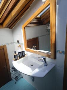 a bathroom with a sink and a mirror at Hostal Pension Artilleiro in Santiago de Compostela +78 photos