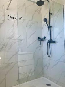a shower with a glass door with the words donate at Kaz Sara in Saint-Pierre +9 photos