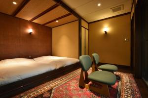 那須町にある那須高原の宿 山水閣のベッドルーム1室(ベッド1台、椅子2脚付)