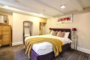 a bedroom with a large bed and a dresser at Chester Apartments in Chester
