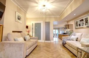 a living room with two couches and a kitchen at Chester Apartments in Chester