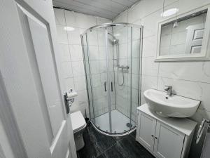 a bathroom with a glass shower and a sink at Modern 1BR Home in Clayton-le-moors in Clayton le Moors