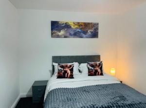 a bedroom with a bed with two animals on it at Modern 1BR Home in Clayton-le-moors in Clayton le Moors +14 photos