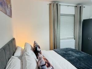 a bedroom with a bed with white sheets and a window at Modern 1BR Home in Clayton-le-moors in Clayton le Moors +14 photos