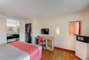ウィチタにあるMotel 6-Wichita, KSのベッドとデスクが備わるホテルルームです。