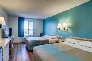 a hotel room with two beds and a television at Motel 6-Greenwood Village, CO - Denver - South Tech Center in Greenwood Village +25 photos