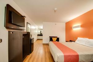a hotel room with a bed and a flat screen tv at Motel 6-Jennings, LA in Jennings +29 photos