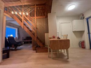 a room with a table and chairs in a barn at CC`s Green house in Tromsø